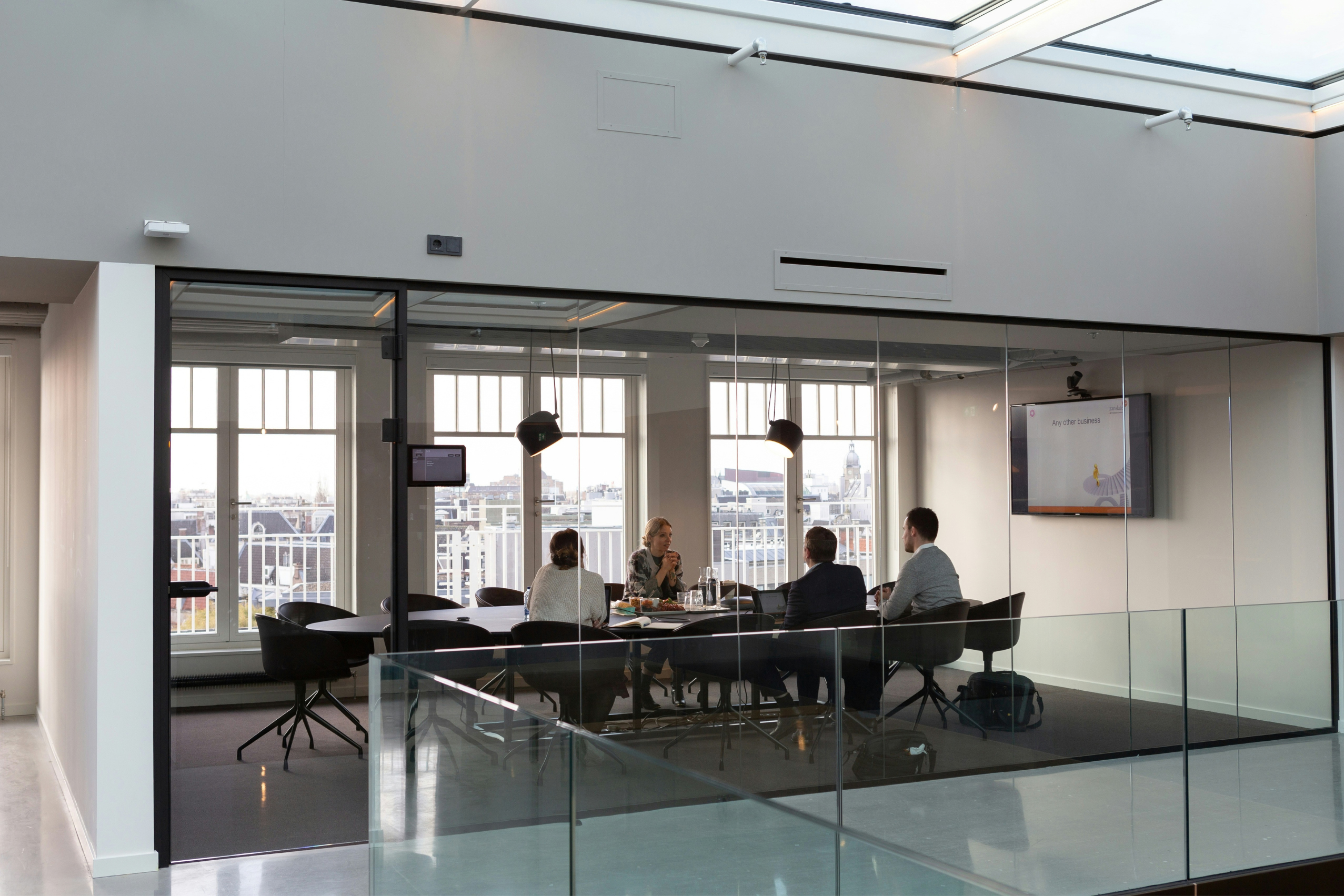 Team meeting in a glass-walled boardroom