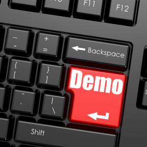 Red Demo Key on Keyboard – Book a Sincron HR Demo Black computer keyboard with a red Enter key labelled "Demo"